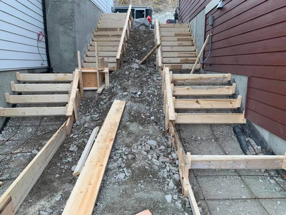 Two sets of wooden formed stairs that are ready for concrete